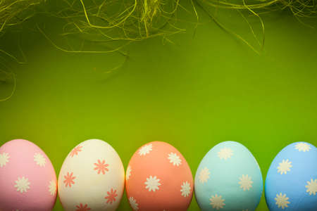 Colored Easter eggs and green background