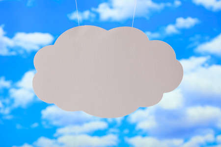 Blank paper sheet in the shape of cloud on sky backgroundの写真素材