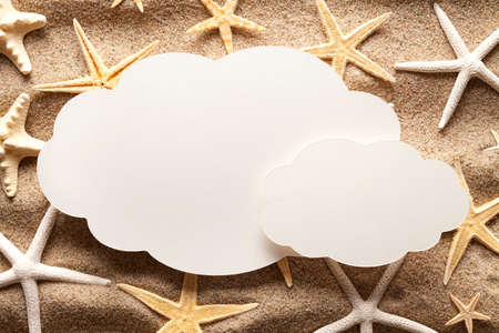 Blank paper sheet and shells on beachの写真素材