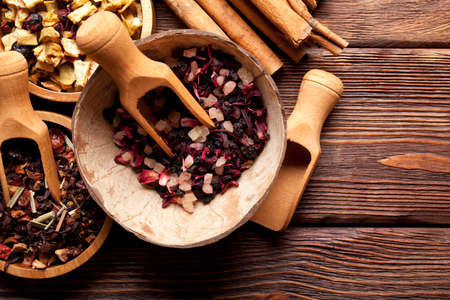 Various kinds of tea and cinnamon sticks on wooden tableの写真素材