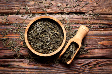 Dried tea leaves on wooden backgroundの写真素材