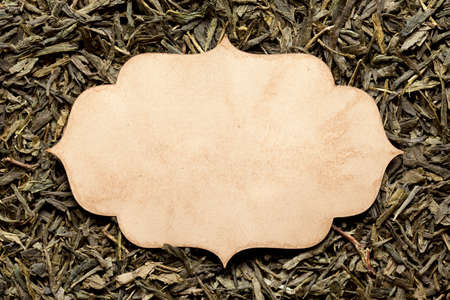 Blank paper card on dried tea leavesの写真素材