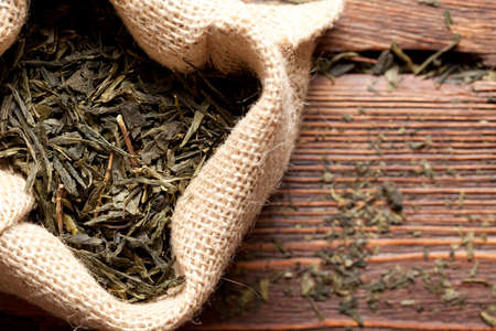 Dried tea leaves in jute bagの写真素材