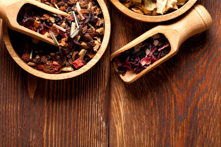 Dried tea leaves on wooden backgroundの写真素材