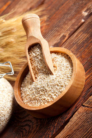 Buckwheat in bowl and jar on wooden tableの写真素材