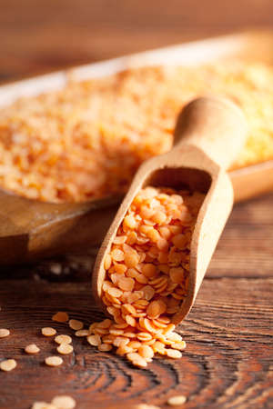 Red lentils in scoop and bowlの写真素材