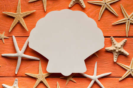 Paper sheet in the shape of the shell on wooden backgroundの写真素材