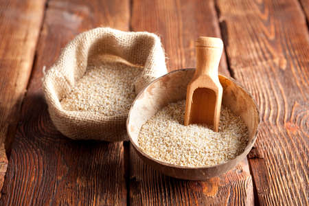 Buckwheat in wooden bowl and bagの写真素材