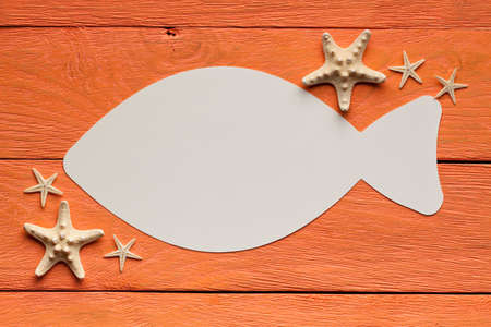 Paper sheet in the shape of the fish on wooden backgroundの写真素材