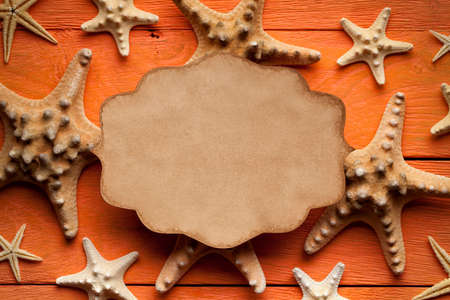 Blank paper sheet and starfish on wooden background