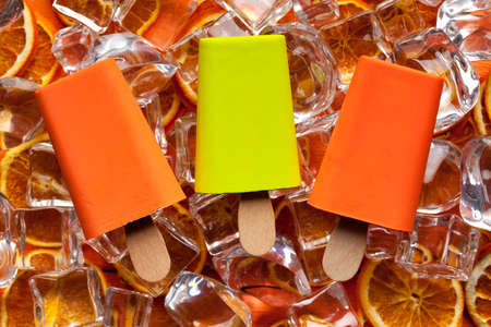 Three ice lollies and ice cubes