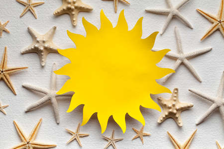 Paper sheet in the shape of the sun on paper backgroundの写真素材