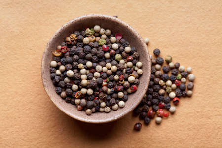 Mix of pepper in bowl on paper backgroundの写真素材