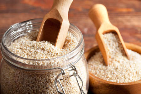 Buckwheat in a jar and wooden bowlの写真素材