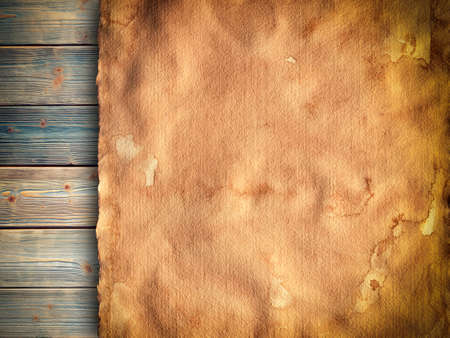 Old stained paper sheet on wooden backgroundの写真素材