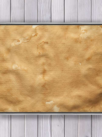 Old stained paper sheet on wooden backgroundの写真素材