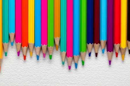 Colourful pencils on paper backgroundの写真素材