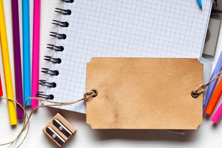 School supplies and blank label on paper backgroundの写真素材