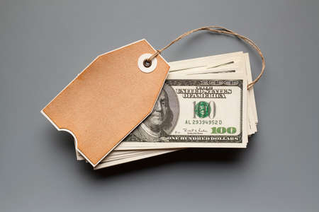 Hundred dollar bills and blank paper cardの写真素材