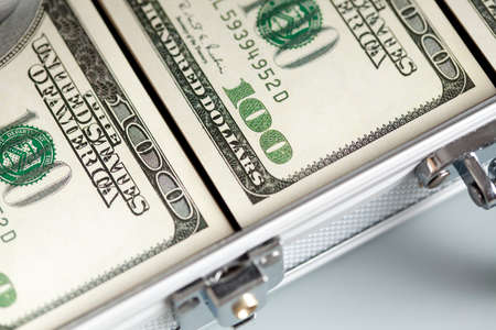 Metallic business suitcase and dollar billsの写真素材
