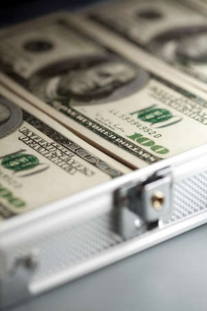 Metallic business suitcase and dollar billsの写真素材