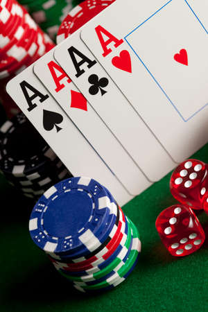 Playing cards, poker chips, and dices on green table