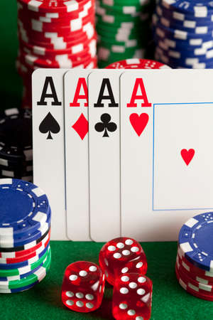 Playing cards, poker chips, and dices on green table