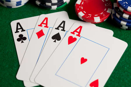 Playing cards and poker chips on green table