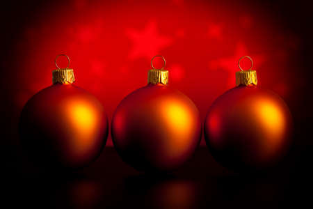 Three baubles on red backgroundの写真素材