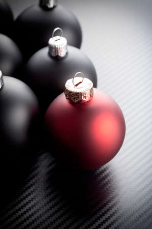 Black and red christmas baubles on carbon backgroundの写真素材