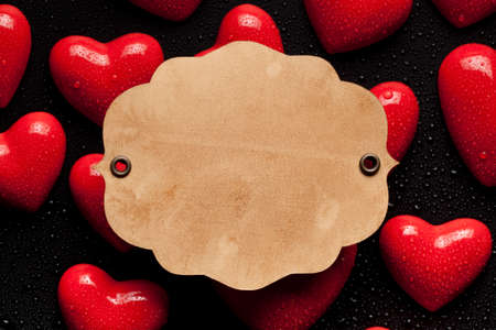 Paper label on red hearts backgroundの写真素材