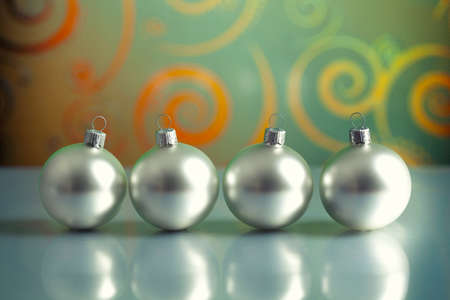 Four silver baubles on abstract backgroundの写真素材