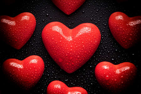 Many red hearts on black backgroundの写真素材