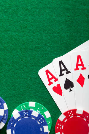 Playing cards, poker chips on green tableの写真素材