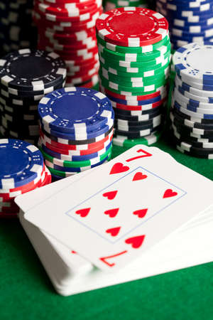 Playing cards and poker chips on green tableの写真素材