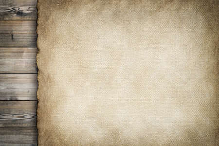 Old stained paper sheet on wooden backgroundの写真素材