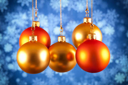 Red and gold baubles on blue backgroundの写真素材