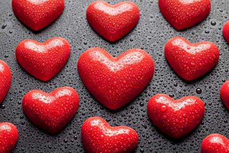 Water drops on red heartsの写真素材