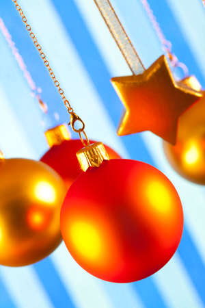 Christmas baubles and stars on patterned backgroundの写真素材
