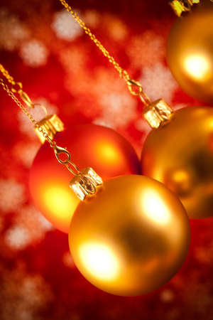 Christmas baubles and white snowflakes on red backgroundの写真素材