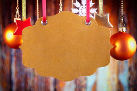 Blank paper label, Christmas baubles and snowflake on wooden wall backgroundの写真素材