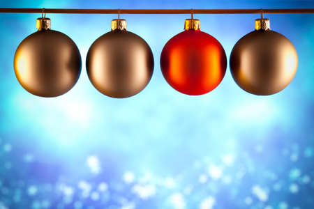 Four Christmas baubles on blue backgroundの写真素材