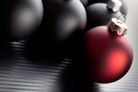 Black and red christmas baubles on carbon backgroundの写真素材