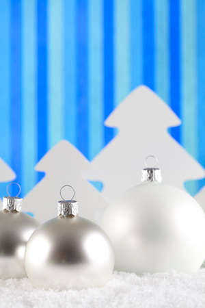 Christmas baubles and trees on snow and abstract backgroundの写真素材