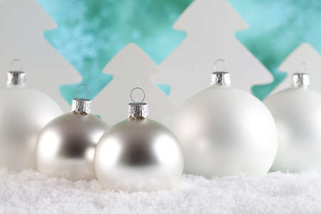Christmas baubles and trees on snow and abstract backgroundの写真素材