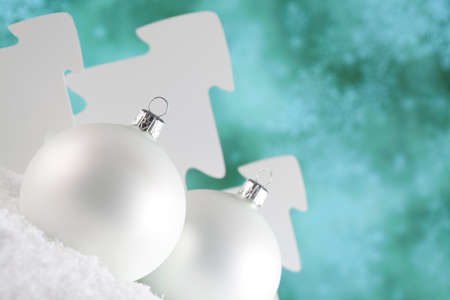 Christmas baubles and trees on snow and abstract backgroundの写真素材