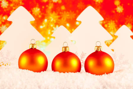 Christmas baubles and trees on snow and abstract backgroundの写真素材