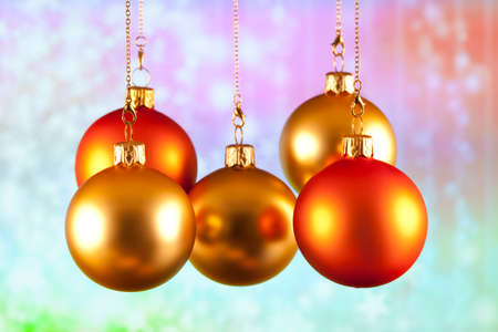 Red and gold baubles on abstract colored backgroundの写真素材