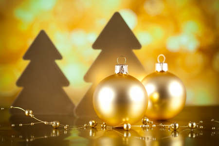 Two Christmas baubles and trees on bokeh backgroundの写真素材