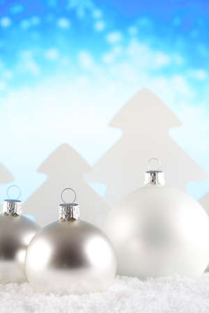 Christmas baubles and trees on snow and abstract backgroundの写真素材